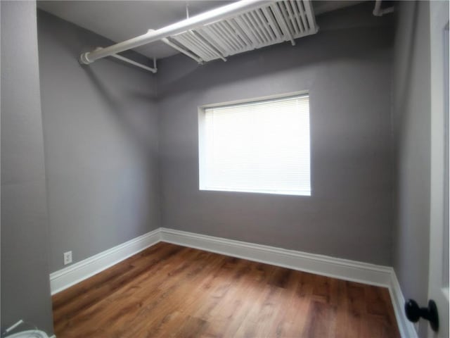 spacious closet featuring dark hardwood / wood-style floors