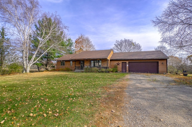 ranch-style home featuring a front yard and a garage