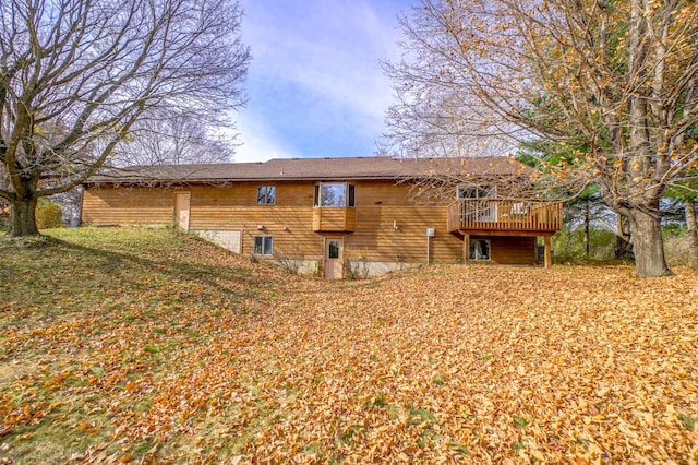 back of property featuring a wooden deck