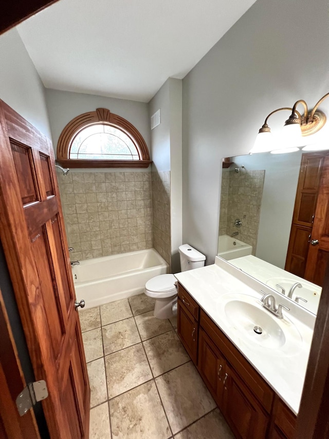 full bathroom featuring vanity, tiled shower / bath combo, toilet, and tile patterned flooring