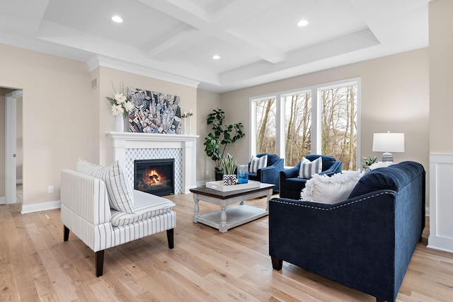 living room with beamed ceiling, coffered ceiling, light hardwood / wood-style flooring, and a fireplace