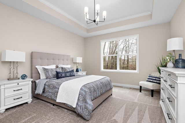 carpeted bedroom featuring ornamental molding, a notable chandelier, and a tray ceiling