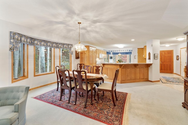 dining space featuring light colored carpet