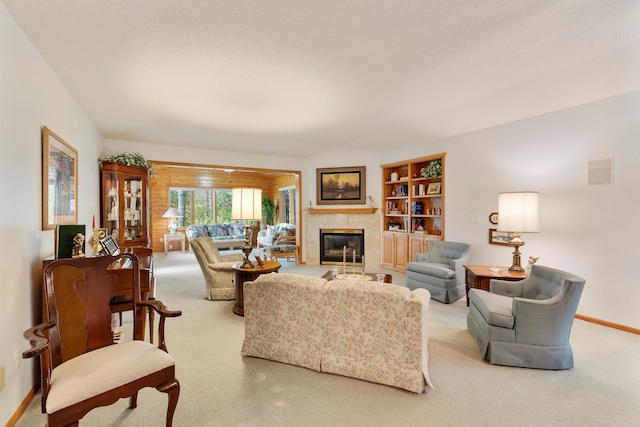 carpeted living room with built in features and a fireplace