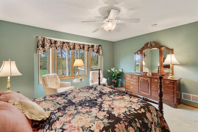 bedroom featuring a textured ceiling, ceiling fan, and carpet flooring