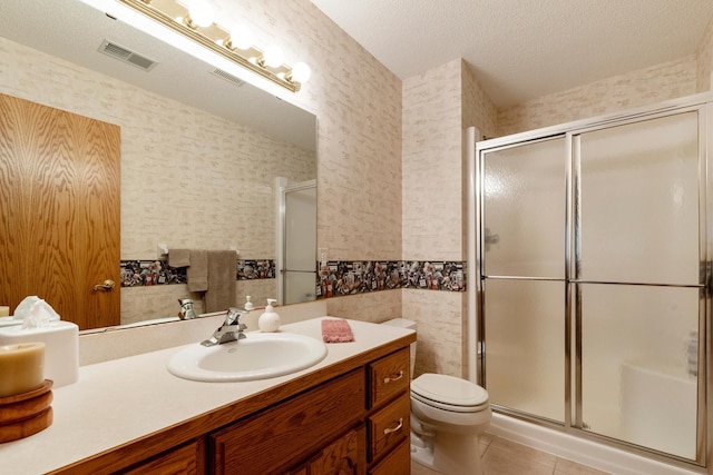 bathroom featuring walk in shower, tile patterned floors, vanity, and a textured ceiling