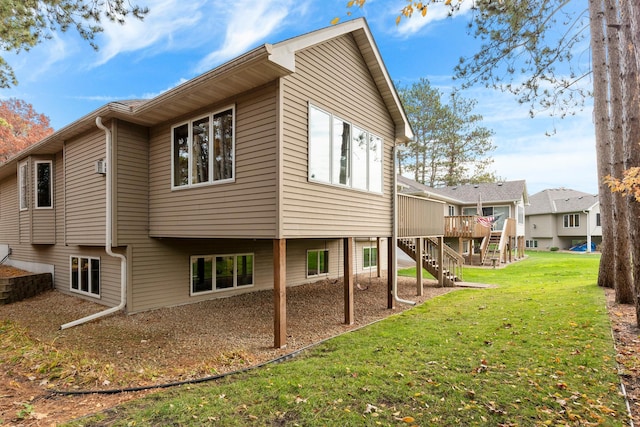 back of house featuring a wooden deck and a yard