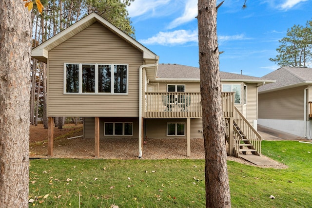 back of property featuring a lawn and a deck