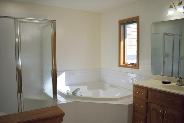 bathroom featuring vanity and shower with separate bathtub