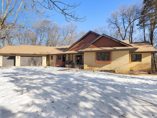 single story home with a garage and covered porch