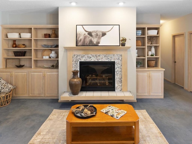 living room featuring dark colored carpet and a fireplace