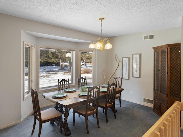 carpeted dining space with an inviting chandelier and a textured ceiling