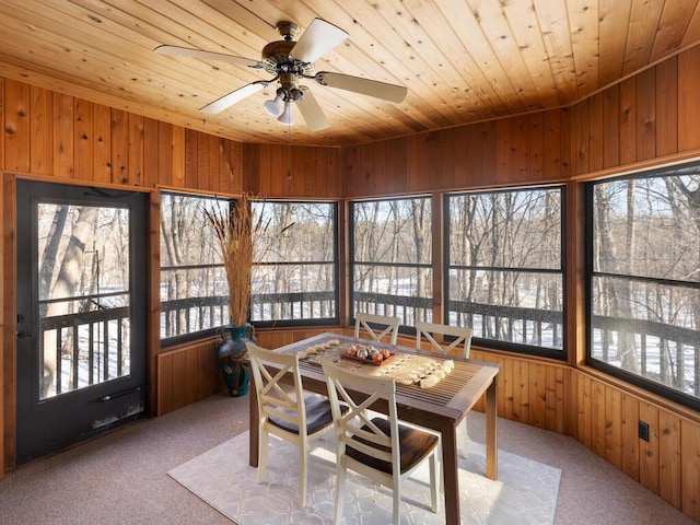 sunroom / solarium with ceiling fan and wood ceiling