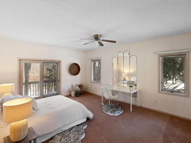 carpeted bedroom with multiple windows, ceiling fan, and a textured ceiling