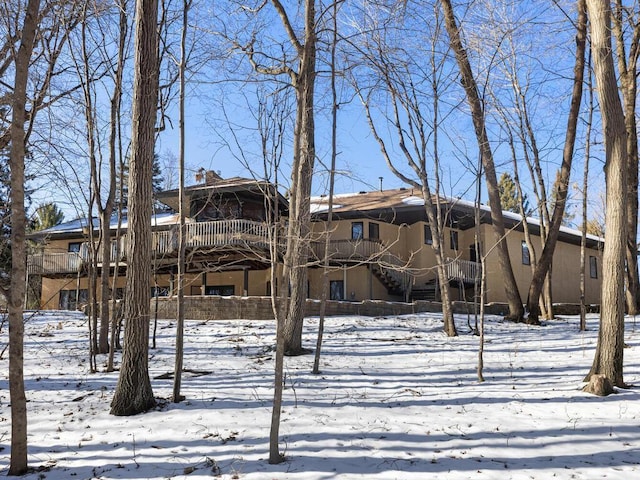 view of snow covered rear of property