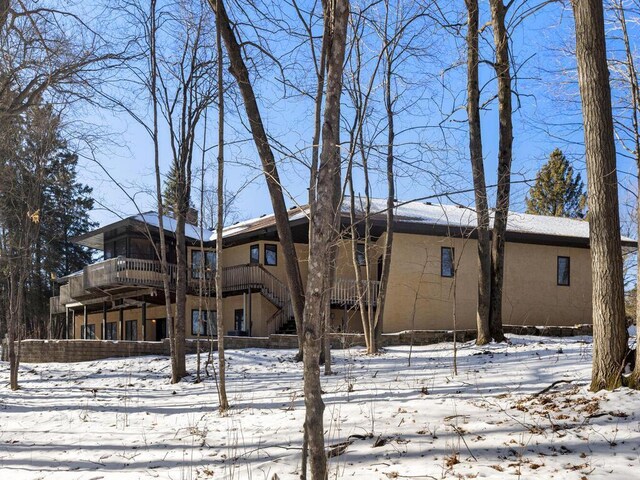 snow covered property featuring a deck