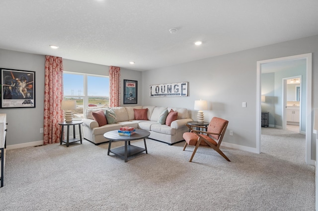 carpeted living room featuring baseboards, a textured ceiling, and recessed lighting