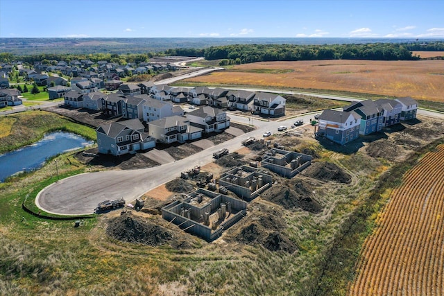 birds eye view of property with a water view and a residential view