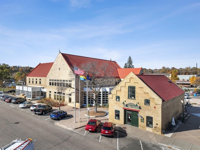 view of building exterior with uncovered parking