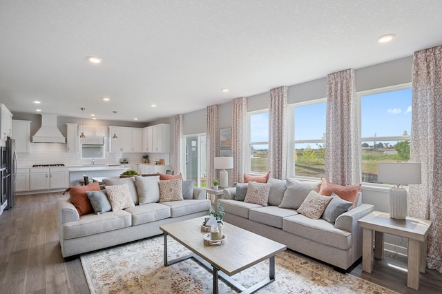 living room featuring plenty of natural light, light wood-type flooring, and recessed lighting