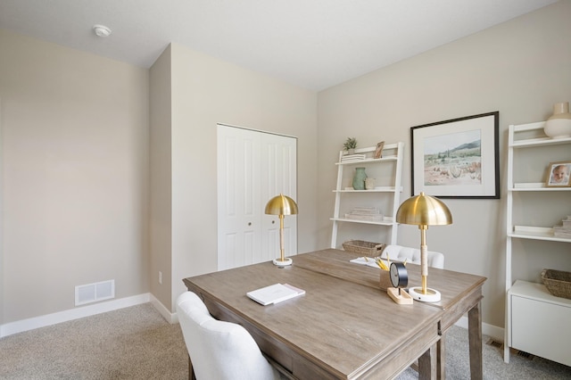 carpeted office with visible vents and baseboards