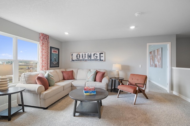 living room featuring light carpet, baseboards, and recessed lighting