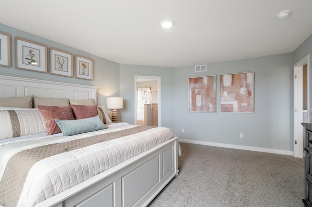 bedroom with baseboards, visible vents, ensuite bathroom, and light colored carpet