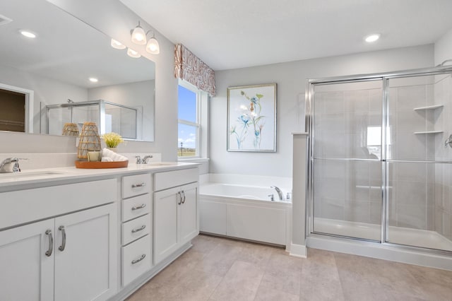 full bathroom with a garden tub, double vanity, recessed lighting, a stall shower, and a sink