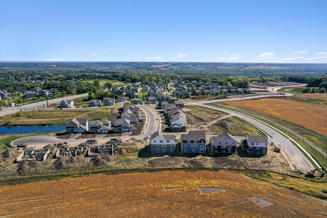 birds eye view of property with a water view and a residential view