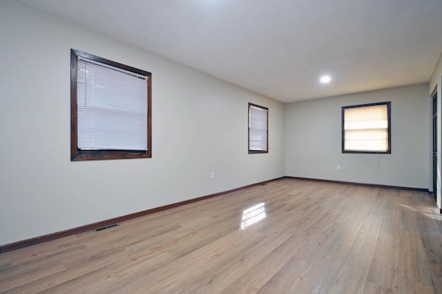 unfurnished room with light hardwood / wood-style floors