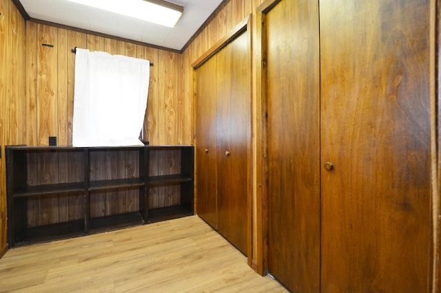 interior space featuring wooden walls and light hardwood / wood-style floors