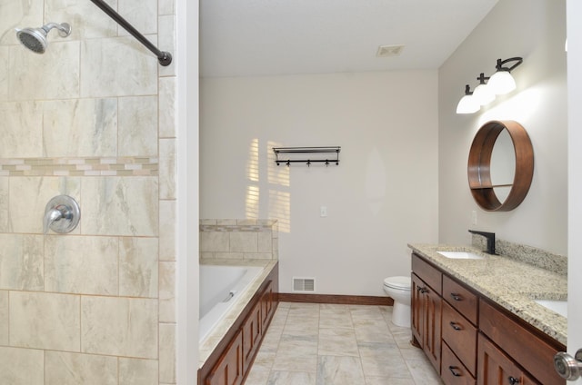 bathroom featuring toilet, vanity, and a bathing tub