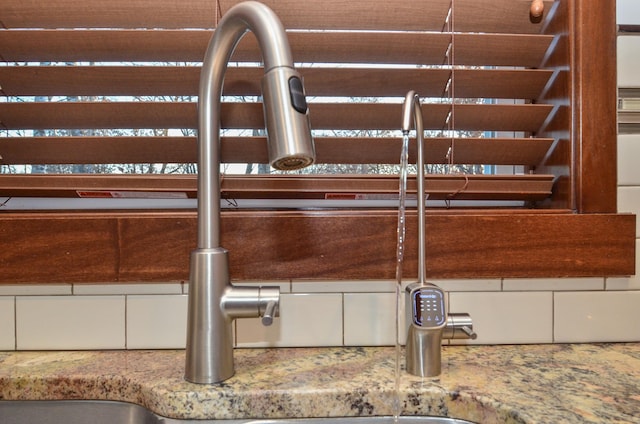 interior details featuring light stone counters and sink