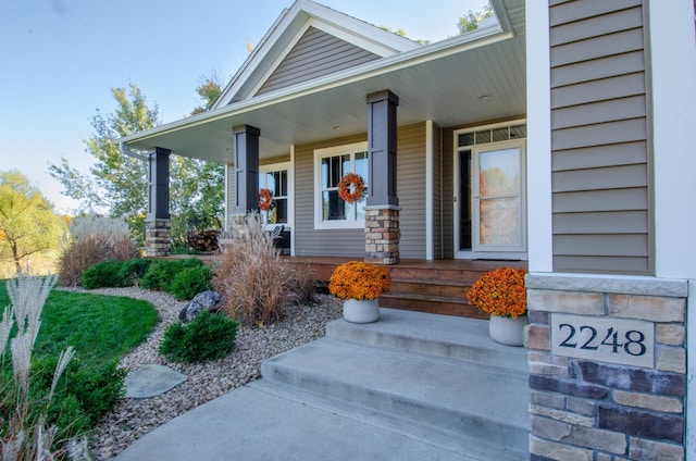 view of exterior entry with a porch