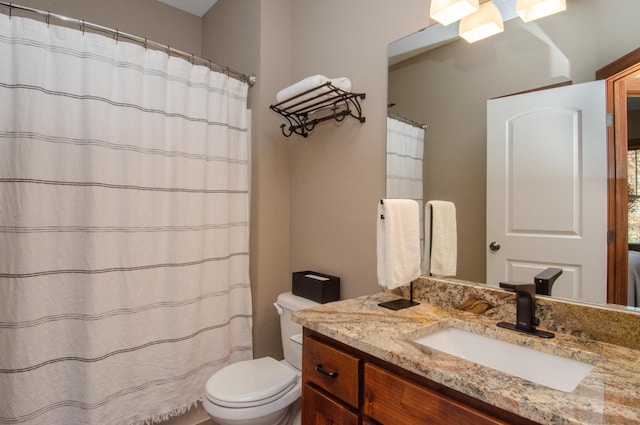 bathroom featuring toilet and vanity