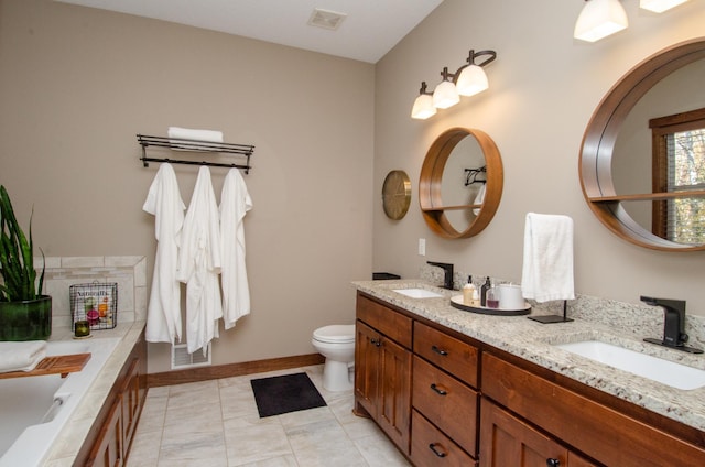 bathroom with toilet, vanity, tile patterned flooring, and a bath