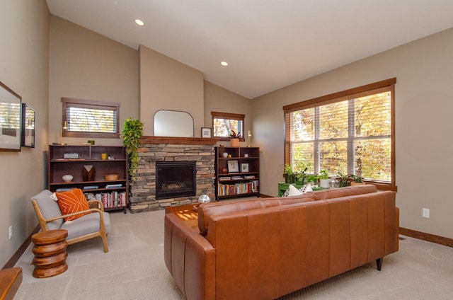 carpeted living room with a stone fireplace and vaulted ceiling