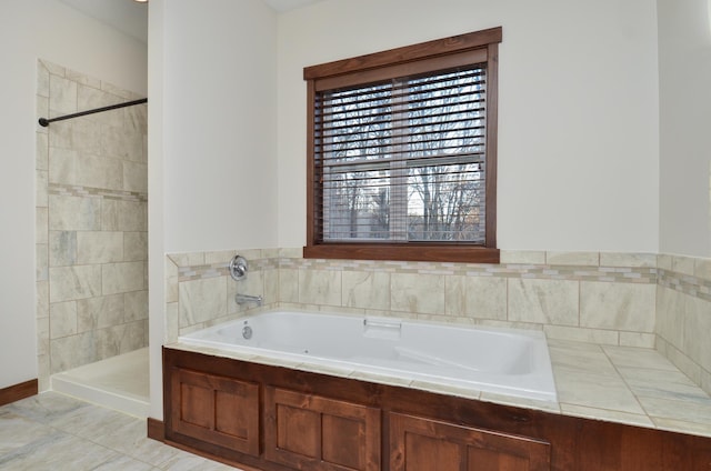 bathroom with a tile shower and a bath