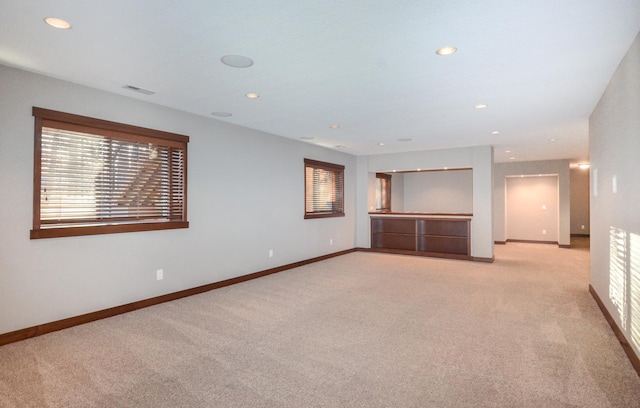 empty room featuring recessed lighting, visible vents, light carpet, and baseboards