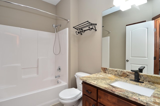 bathroom featuring toilet, shower / washtub combination, and vanity