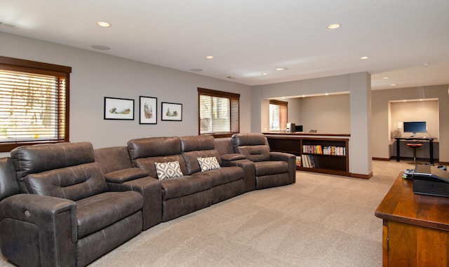 living room featuring light carpet, visible vents, baseboards, and recessed lighting