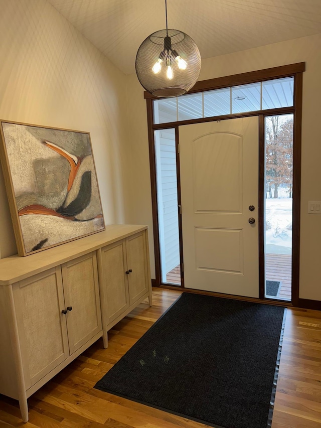 foyer with light wood finished floors and baseboards