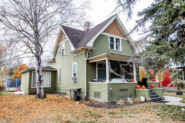 view of front of house featuring cooling unit and a sunroom