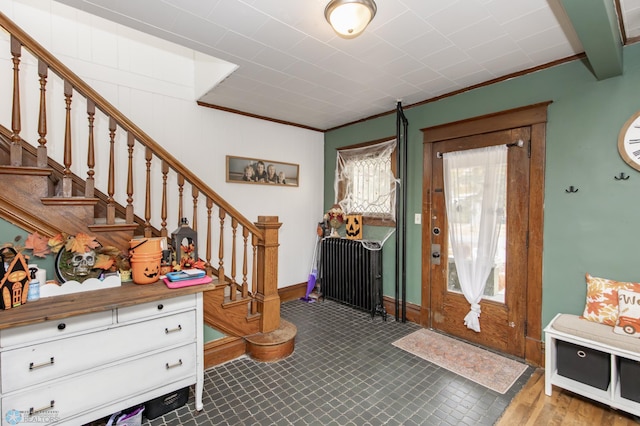 foyer entrance featuring crown molding