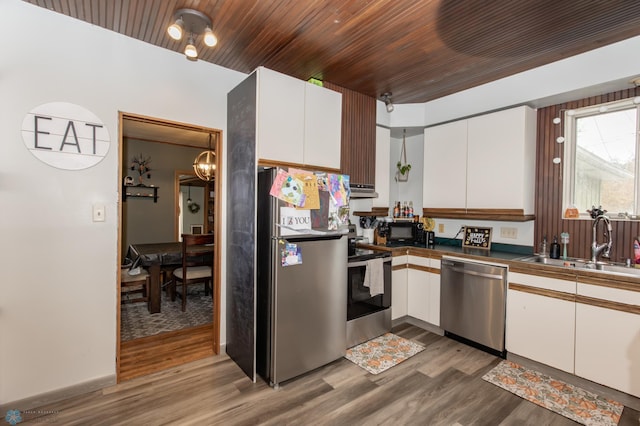 kitchen featuring sink, hardwood / wood-style floors, white cabinetry, and stainless steel appliances