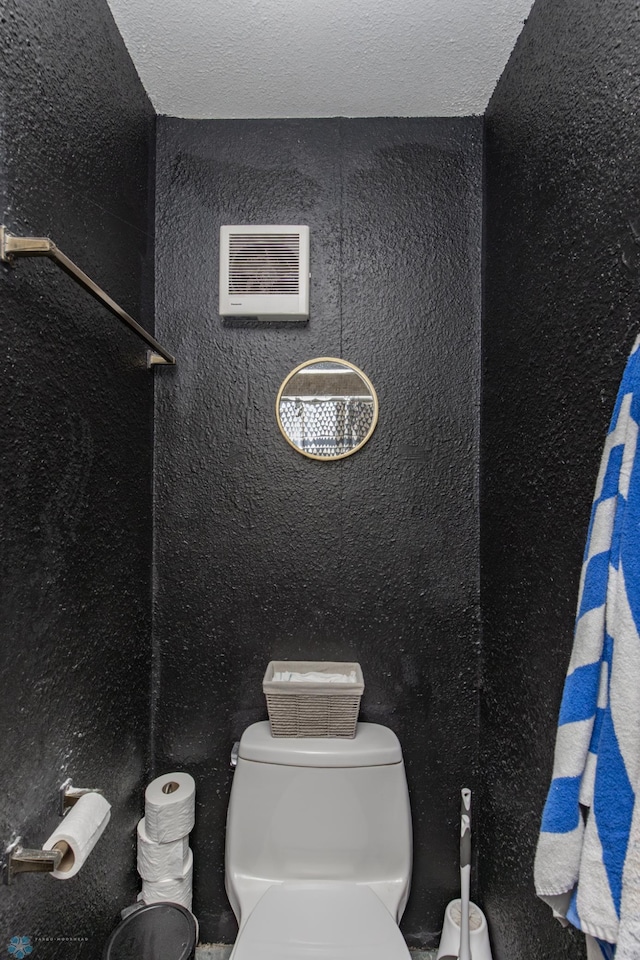 bathroom featuring toilet and a textured ceiling