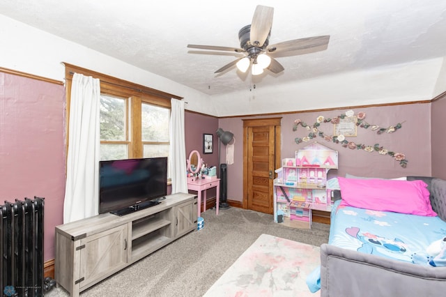 interior space with radiator heating unit, a textured ceiling, and ceiling fan