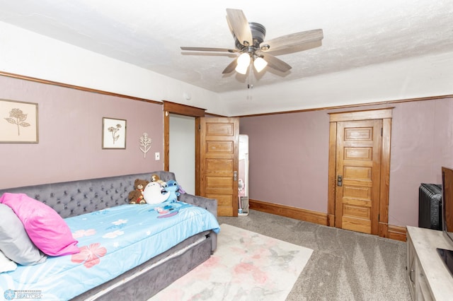 bedroom with a textured ceiling, carpet, and ceiling fan