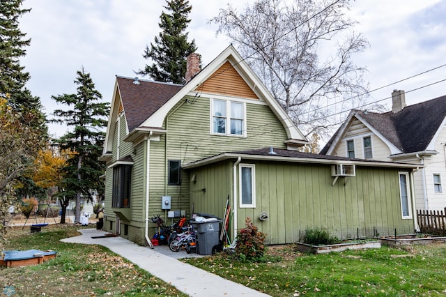 rear view of property with a lawn