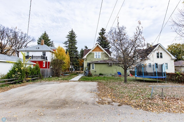 bungalow-style house with a trampoline